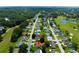 Elevated aerial view showcasing residential area near a golf course; a home highlighted with a red arrow at 9790 Se 175Th St, Summerfield, FL 34491