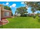 Expansive backyard featuring lush green lawn and mature landscaping at 9790 Se 175Th St, Summerfield, FL 34491