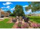 Outdoor patio area with wicker furniture, a table, flowers and a grill for relaxing and entertaining at 9790 Se 175Th St, Summerfield, FL 34491