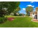 Backyard with lawn and patio area with furniture; perfect for outdoor entertaining and relaxation at 9790 Se 175Th St, Summerfield, FL 34491