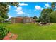 Expansive backyard featuring a lush lawn, patio furniture, and a well-maintained landscape at 9790 Se 175Th St, Summerfield, FL 34491