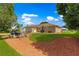 Well-maintained backyard with lush lawn, mulch beds and outdoor furniture perfect for relaxing at 9790 Se 175Th St, Summerfield, FL 34491