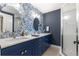 The bathroom features a large vanity with dual sinks, stylish mirrors, and a glass shower enclosure at 9790 Se 175Th St, Summerfield, FL 34491