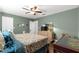 Cozy bedroom features ceiling fan, wood-look flooring, and green walls at 9790 Se 175Th St, Summerfield, FL 34491