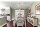 Inviting dining area featuring a stylish light fixture and ample natural light; seamlessly connected to the kitchen at 9790 Se 175Th St, Summerfield, FL 34491