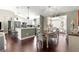 Open concept dining area with modern furnishings and decor leading to the kitchen and other living spaces at 9790 Se 175Th St, Summerfield, FL 34491