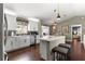 Modern kitchen with white cabinets, stainless steel appliances, a breakfast bar, and pendant lighting at 9790 Se 175Th St, Summerfield, FL 34491