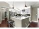 Well-equipped kitchen with stainless steel appliances, breakfast bar and white cabinets at 9790 Se 175Th St, Summerfield, FL 34491