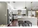 Kitchen features stainless steel appliances, white cabinetry, an island with breakfast bar, and modern fixtures at 9790 Se 175Th St, Summerfield, FL 34491