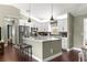 Well-equipped kitchen with stainless steel appliances, breakfast bar and white cabinets at 9790 Se 175Th St, Summerfield, FL 34491