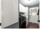 Bright laundry room featuring a front-load washer and dryer and outside access at 9790 Se 175Th St, Summerfield, FL 34491