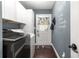Well-organized laundry room with front-load washer and dryer and a door to the outside at 9790 Se 175Th St, Summerfield, FL 34491