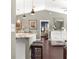 Bright living room with a view into the kitchen with island seating and a glimpse of the Primary bedroom at 9790 Se 175Th St, Summerfield, FL 34491