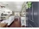 Inviting living space with hardwood floors, neutral decor, and an open layout connecting to the kitchen and dining area at 9790 Se 175Th St, Summerfield, FL 34491