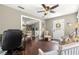 Inviting living room boasts hardwood floors, comfortable seating, and an open layout to the dining area at 9790 Se 175Th St, Summerfield, FL 34491