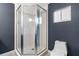 Contemporary shower with mosaic tile accents, glass enclosure, and a white toilet at 9790 Se 175Th St, Summerfield, FL 34491