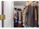 Organized walk-in closet featuring wood floors and ample hanging storage at 9790 Se 175Th St, Summerfield, FL 34491