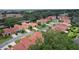 A scenic aerial view showcases homes with barrel tile roofs in a verdant community at 1055 Avenida Sonoma, Lady Lake, FL 32159