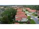 An aerial view of a lovely neighborhood featuring lush landscaping and barrel tile roofs at 1055 Avenida Sonoma, Lady Lake, FL 32159