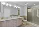 Bathroom featuring a double vanity with white countertops, and a glass enclosed shower at 1055 Avenida Sonoma, Lady Lake, FL 32159