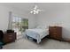 Bright bedroom featuring a ceiling fan, neutral walls, and a window with neighborhood views at 1055 Avenida Sonoma, Lady Lake, FL 32159