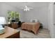Bright bedroom features a fan, window, desk, and wood-look flooring at 1055 Avenida Sonoma, Lady Lake, FL 32159