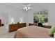 Bright bedroom features a fan, window, desk, dresser and wood-look flooring at 1055 Avenida Sonoma, Lady Lake, FL 32159