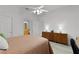 Bright bedroom features a fan, dresser and wood-look flooring at 1055 Avenida Sonoma, Lady Lake, FL 32159