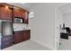 Mini bar featuring custom wood cabinets, sink, microwave, and Galanz mini refrigerator at 1055 Avenida Sonoma, Lady Lake, FL 32159