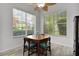 Dining room features wood table, chairs, wood floor, with two windows providing natural light at 1055 Avenida Sonoma, Lady Lake, FL 32159