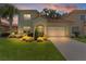 Charming two-story home with a well-manicured lawn, lush landscaping, and a two-car garage at 1055 Avenida Sonoma, Lady Lake, FL 32159