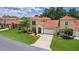 Inviting two-story home boasts a well-manicured lawn and a two-car garage at 1055 Avenida Sonoma, Lady Lake, FL 32159