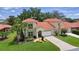Charming home with well-kept lawn, a two-car garage and manicured landscaping at 1055 Avenida Sonoma, Lady Lake, FL 32159