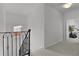 Upstairs hallway featuring decorative railings leading to other rooms at 1055 Avenida Sonoma, Lady Lake, FL 32159