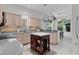 Kitchen with light wood cabinets, a gray countertop, island with storage, and a hanging pot rack at 1055 Avenida Sonoma, Lady Lake, FL 32159