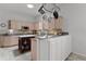 Bright kitchen featuring light wood cabinets, gray countertops, island, and a hanging pot rack at 1055 Avenida Sonoma, Lady Lake, FL 32159