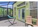 Enclosed patio with hammock, tiled floor, and outdoor furniture at 1055 Avenida Sonoma, Lady Lake, FL 32159