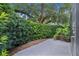 Private patio area surrounded by lush hedges and greenery, perfect for outdoor relaxation at 1055 Avenida Sonoma, Lady Lake, FL 32159