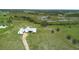 Aerial view of the home showing the surrounding pasture and metal roof at 10711 County Road 561, Clermont, FL 34711