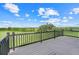 View of the beautiful property from the dark grey wood back deck and black railing at 10711 County Road 561, Clermont, FL 34711