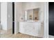 Elegant bathroom with double vanity, sleek mirror, and modern fixtures at 10711 County Road 561, Clermont, FL 34711
