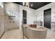 Luxurious bathroom featuring a modern soaking tub, dual shower heads, and sleek fixtures at 10711 County Road 561, Clermont, FL 34711