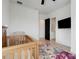 Bedroom featuring a wooden crib and grey arm chair on wood floors with a floral rug at 10711 County Road 561, Clermont, FL 34711