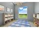 Bright bedroom with custom shelving, natural light, and scenic views at 10711 County Road 561, Clermont, FL 34711
