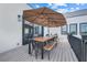 Beautiful deck with a large table, benches, seating and a large umbrella. Great for entertaining guests outdoors at 10711 County Road 561, Clermont, FL 34711