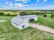 Newly constructed farmhouse with modern design amidst green fields and blue skies at 10711 County Road 561, Clermont, FL 34711