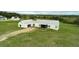 Expansive modern home with a metal roof surrounded by an open green lawn at 10711 County Road 561, Clermont, FL 34711
