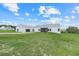 Modern farmhouse in a sprawling field, under a clear sky with fluffy clouds at 10711 County Road 561, Clermont, FL 34711
