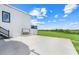 Exterior view showcasing concrete patio and stairs leading to deck, enhanced by outdoor swing and views at 10711 County Road 561, Clermont, FL 34711