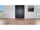 Foyer with porcelain wood-look floors, modern black doors, and a stately stag painting at 10711 County Road 561, Clermont, FL 34711